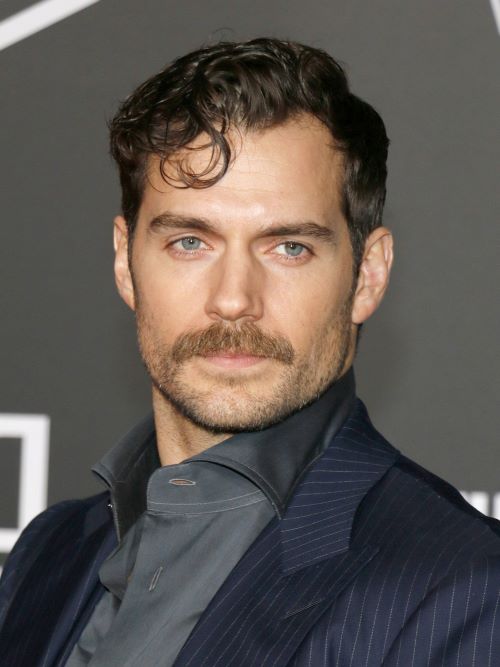 Henry Cavill wearing a manly moustache and slight beard stubble