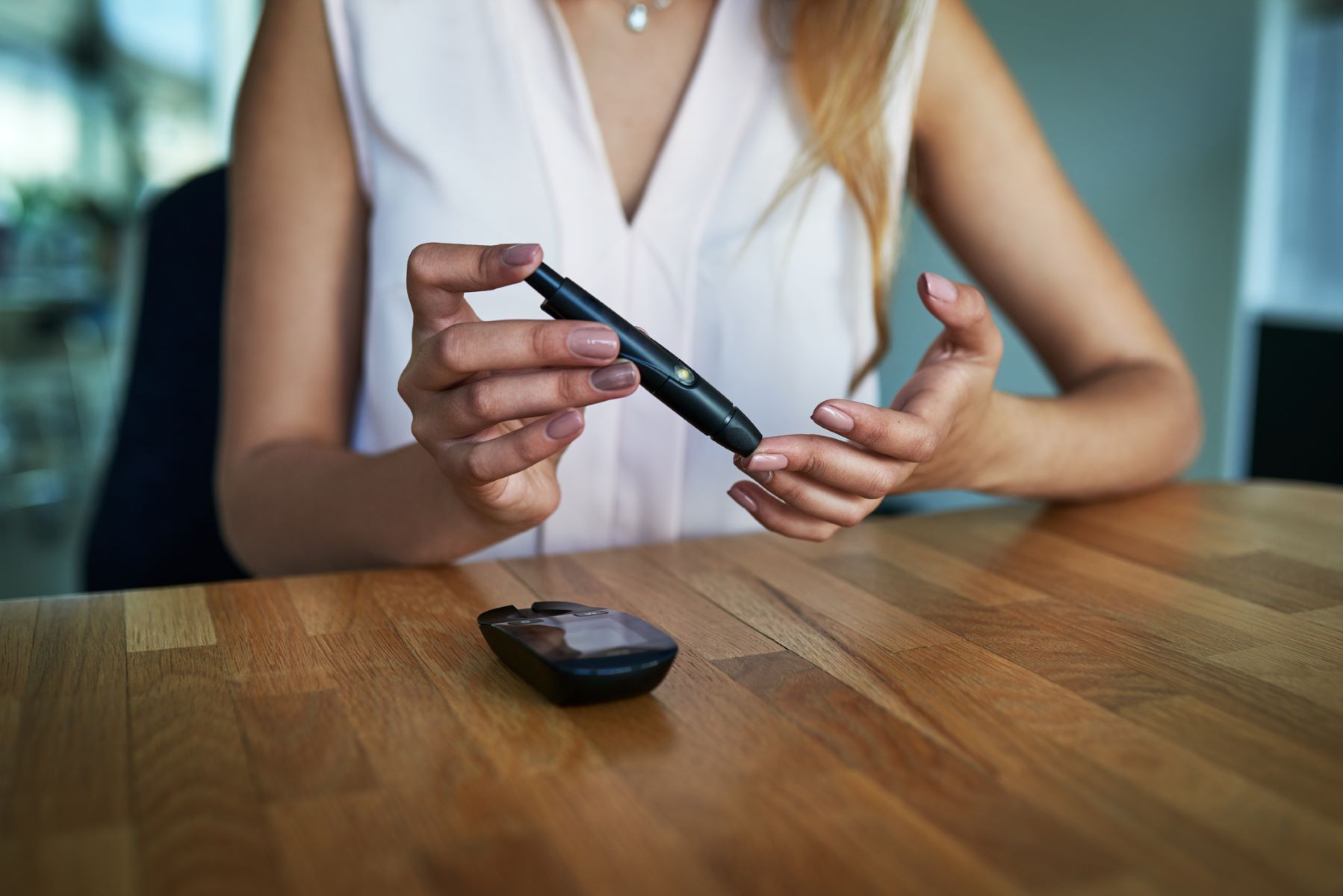 Woman with diabetes measuring her blood sugar levels