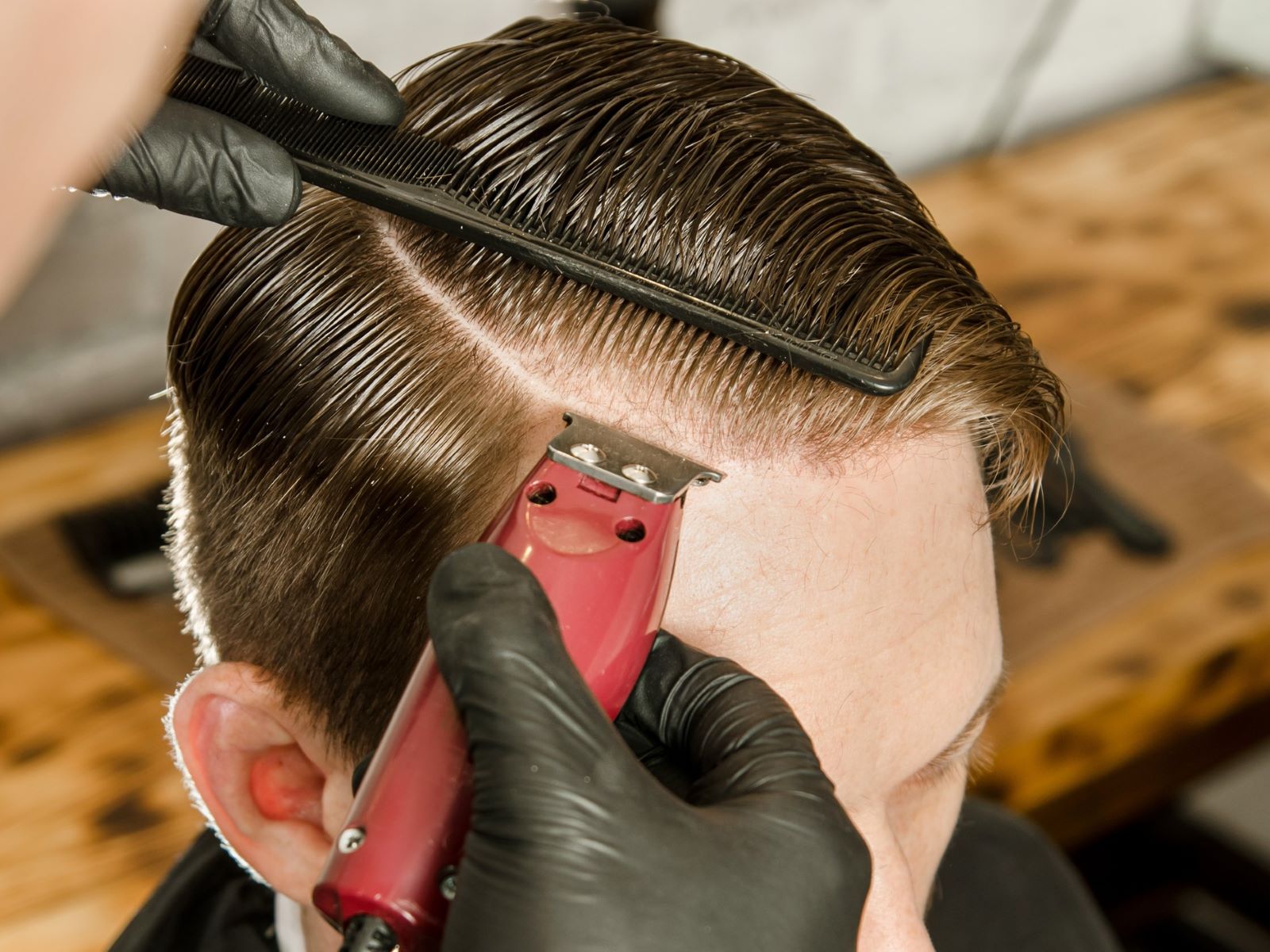 Barber cutting in a regulation haircut