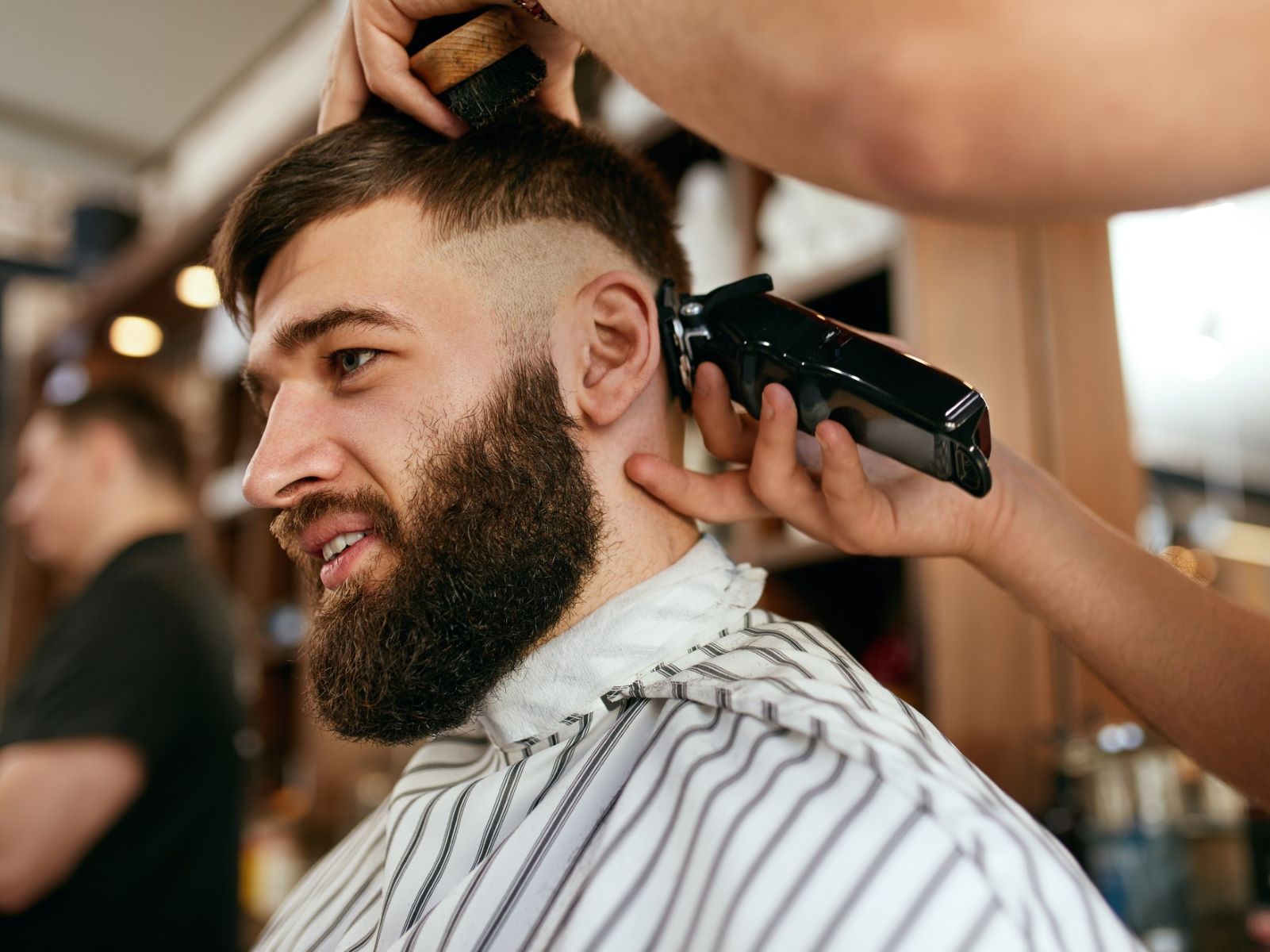 Barber styling a French crop