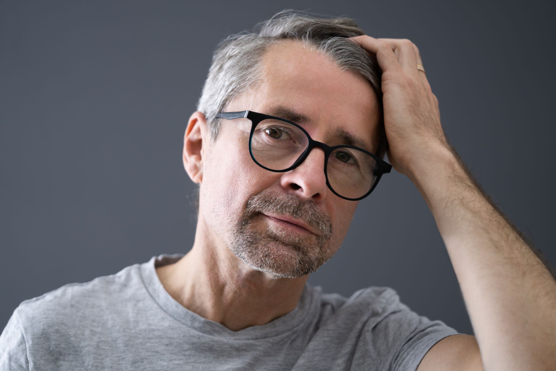 Man checking his scalp for hair regrowth following Minoxidil shampoo use