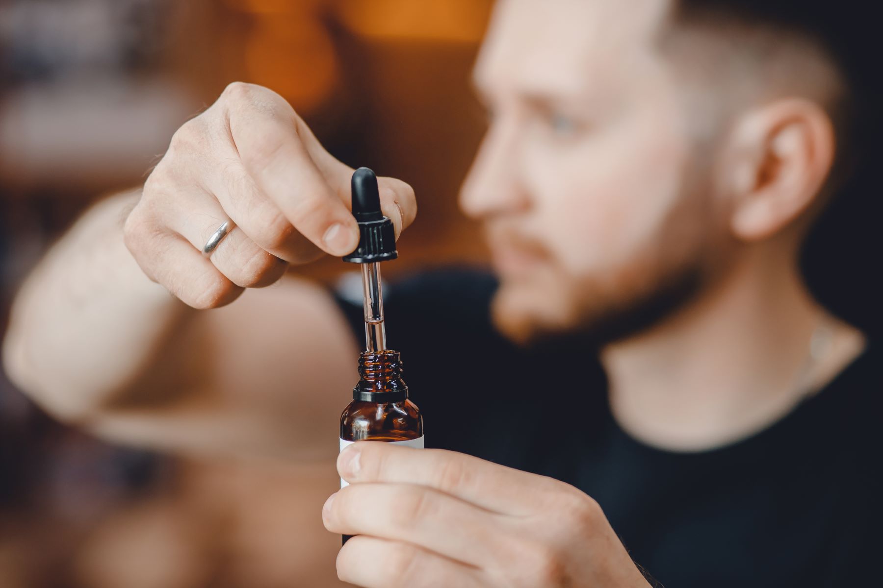 Man using rosemary oil for his beard