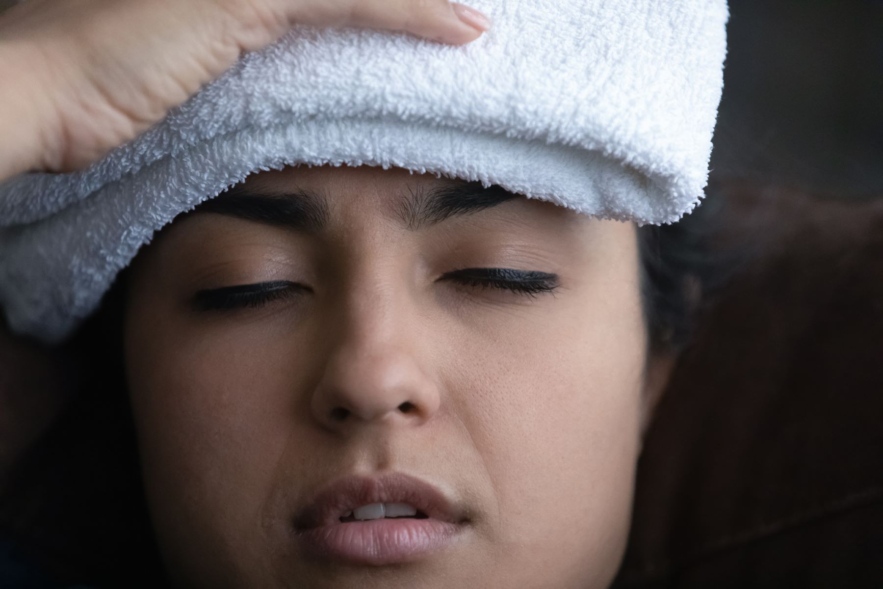 Woman treating scalp tenderness at home
