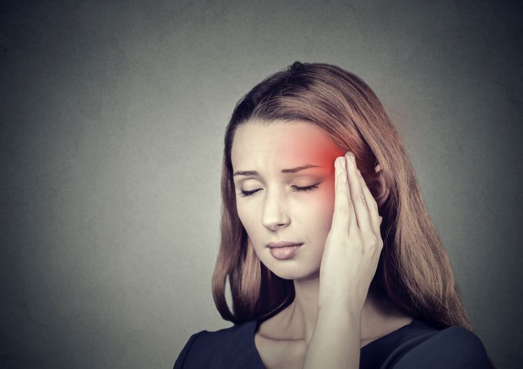 Woman with a migraine headache