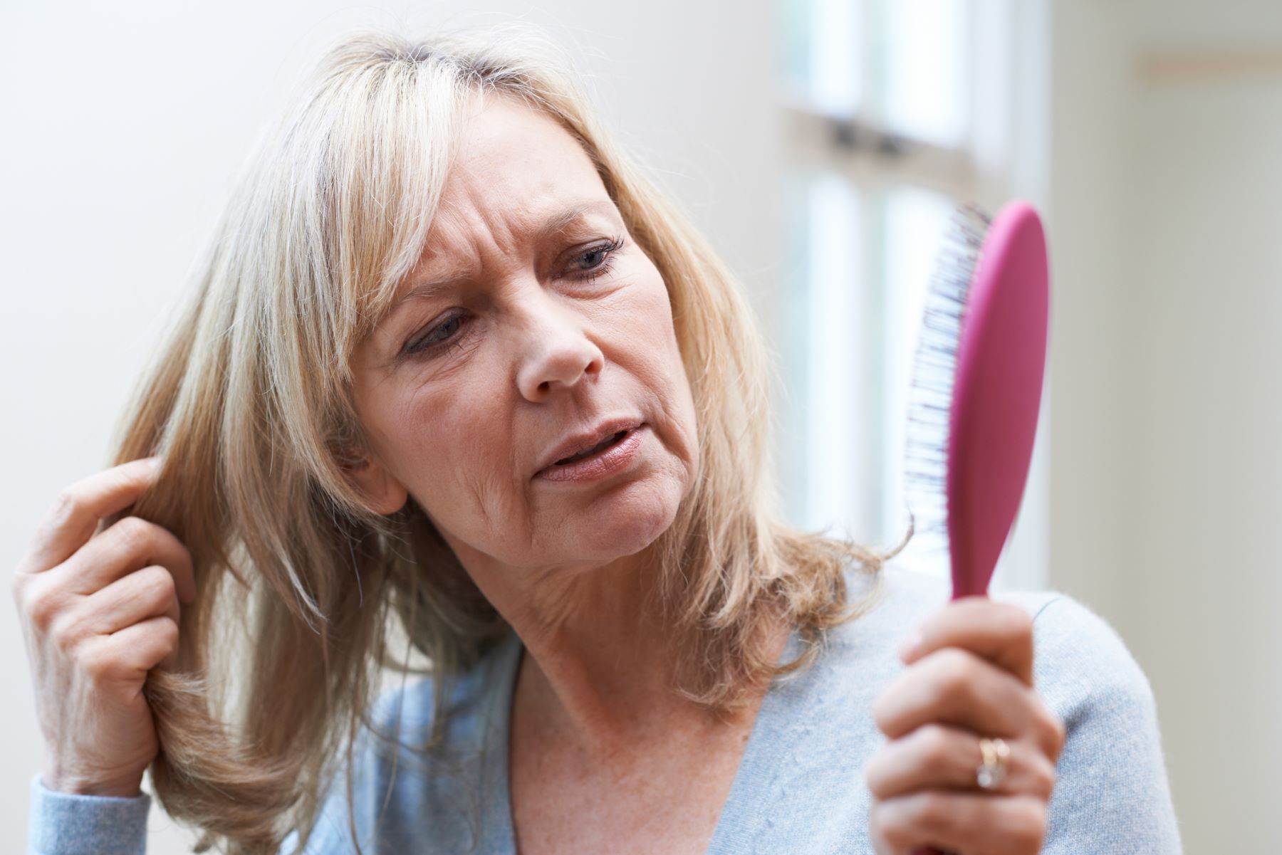 woman concerned with hair loss due to hormonal imbalances