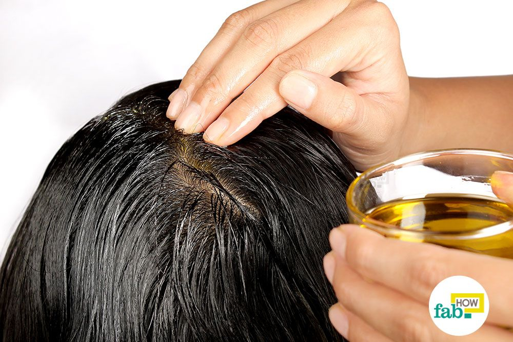 olive oil being applied to scalp