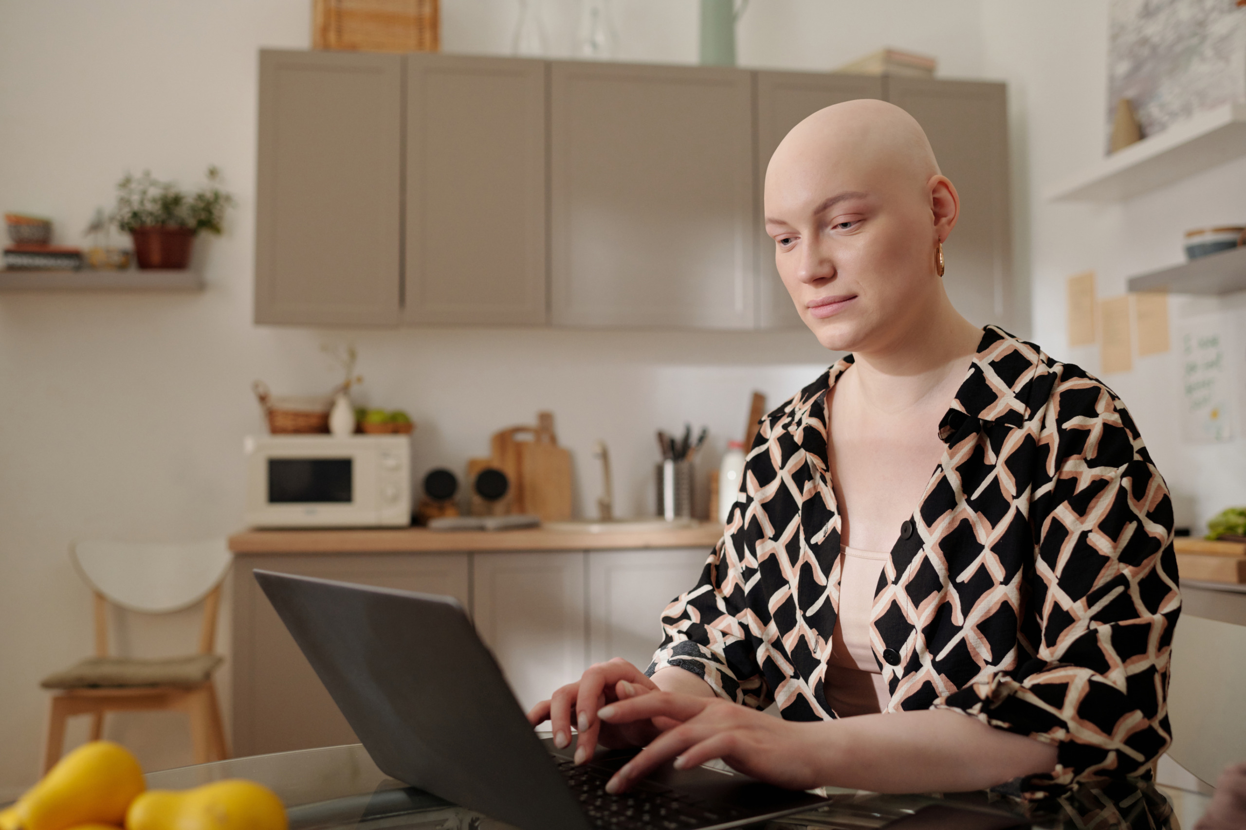Bald woman on her laptop