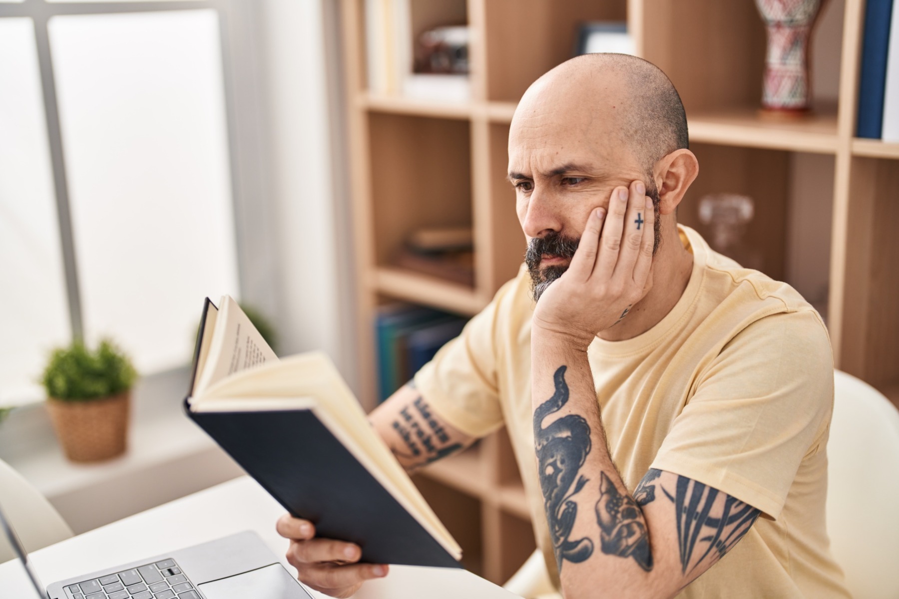 bald man reading a book