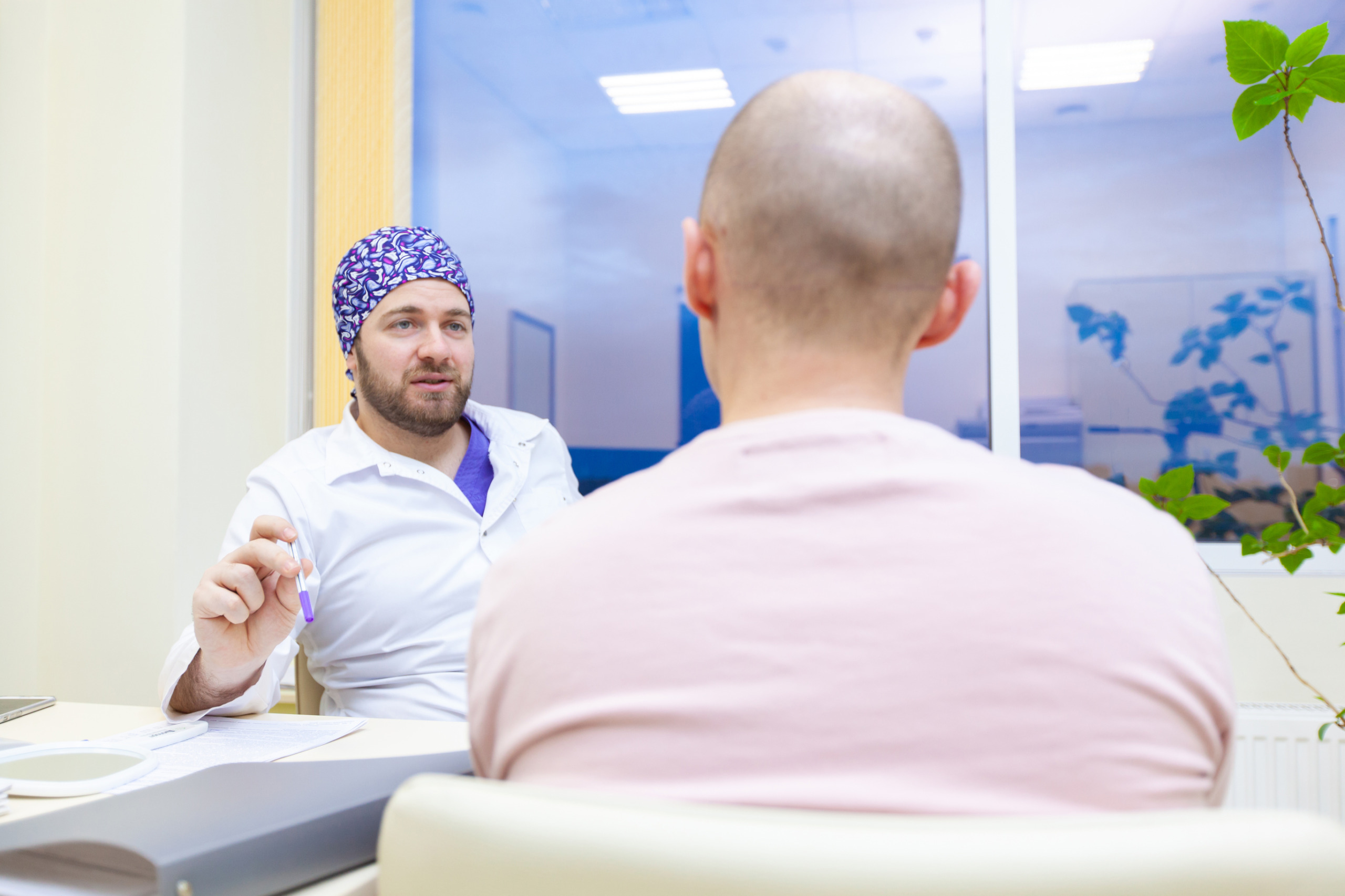 bald patient consulting with a doctor