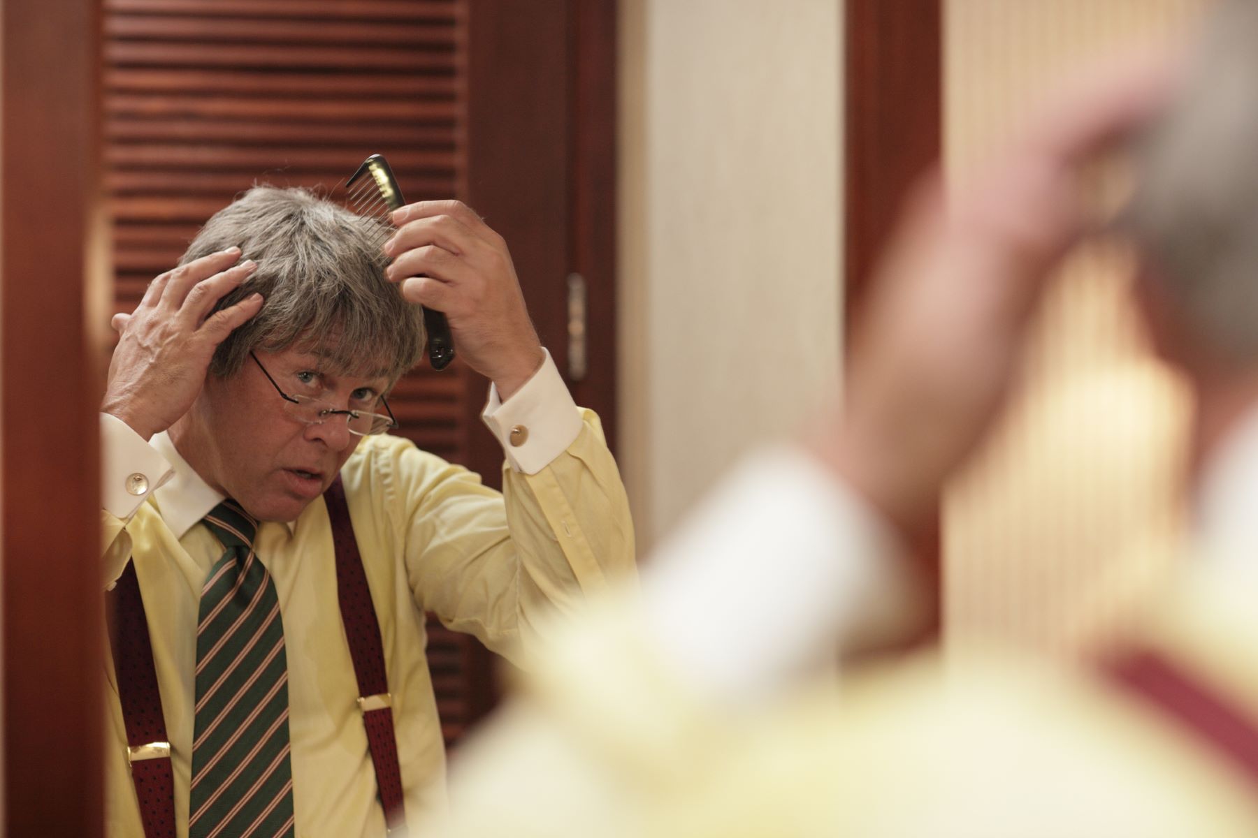 Man adjusting his hair replacement system