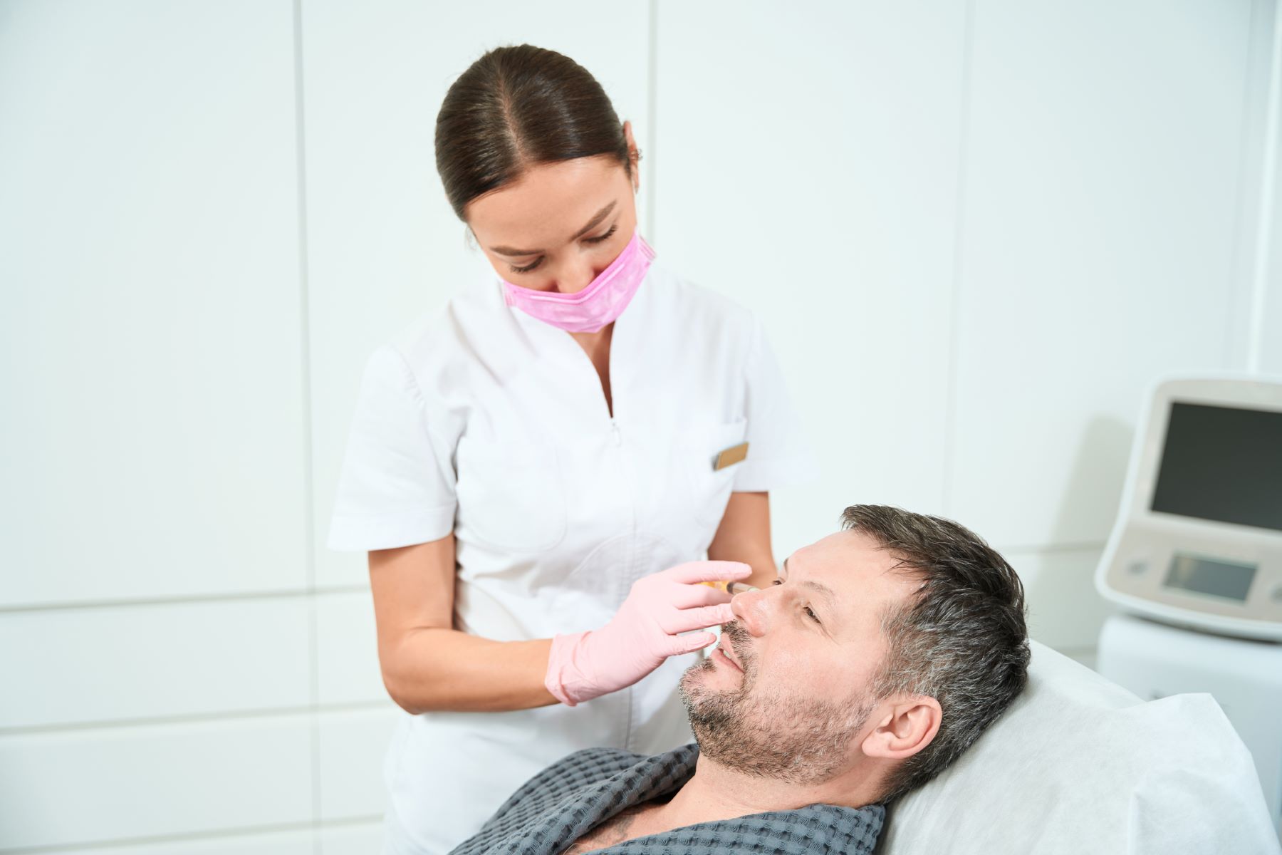 Man receiving PRP therapy to stimulate beard growth