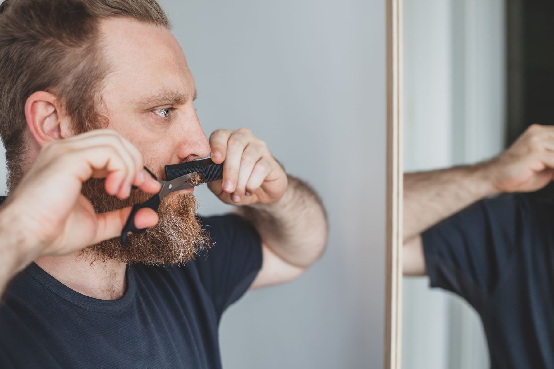 Man trimming his moustache