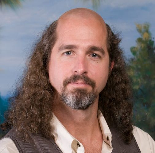 Man with long hair and a bald crown