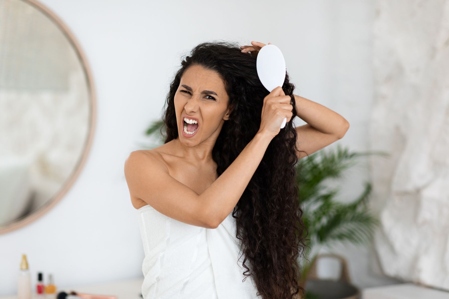 Woman being rough on her hair strands while brushing