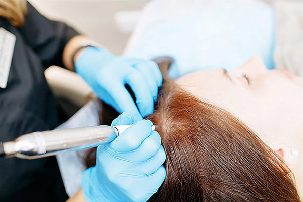 Woman Getting Scalp Micropigmentation
