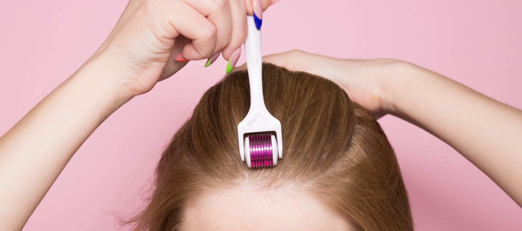Woman using a derma roller on her scalp