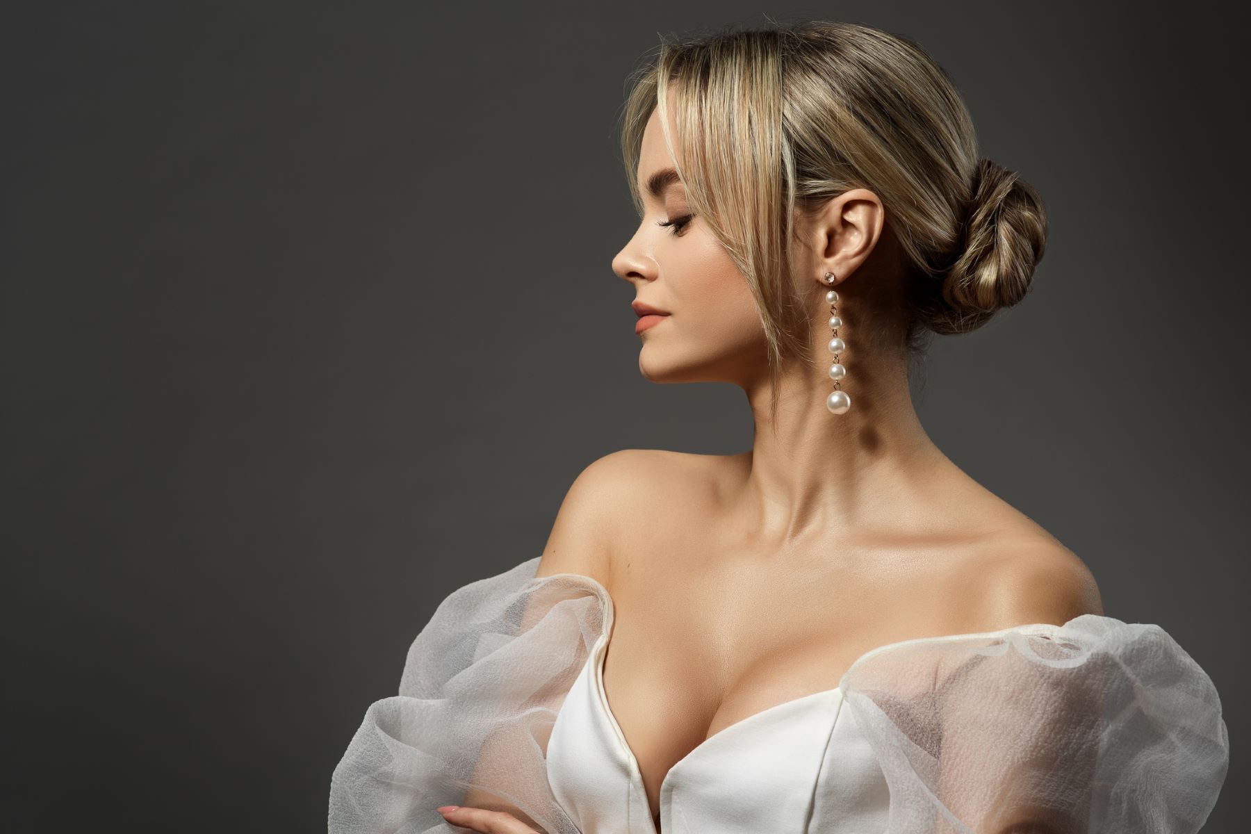 Bride with a tight low bun with curtain bangs