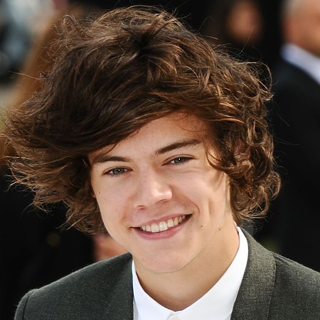 Harry with a messy, medium-length, textured style