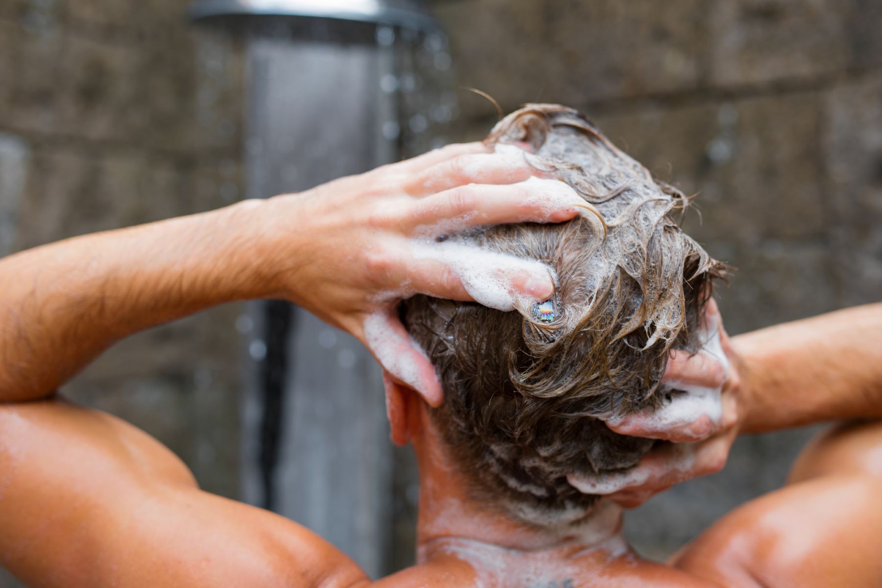 Man using anti-dandruff shampoo