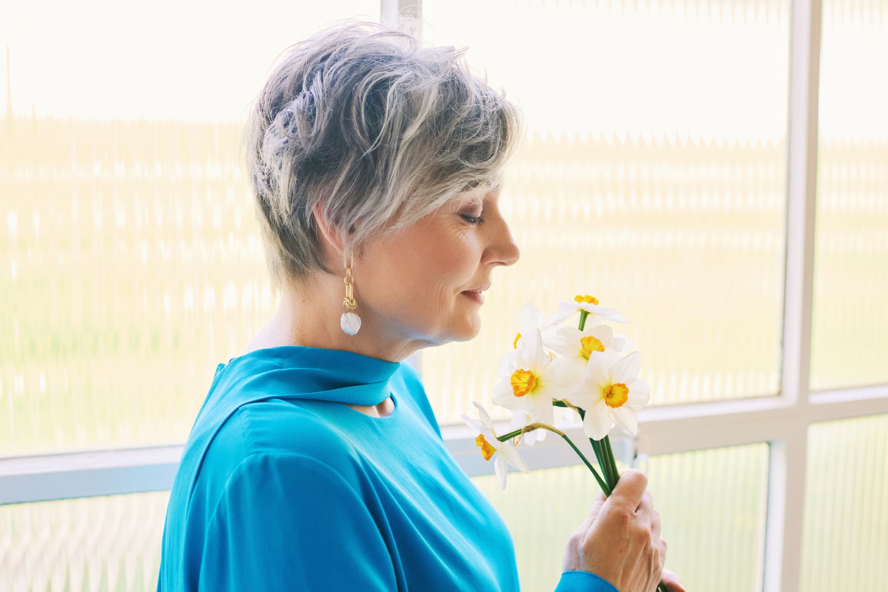 Mature woman with short grey healthy hair