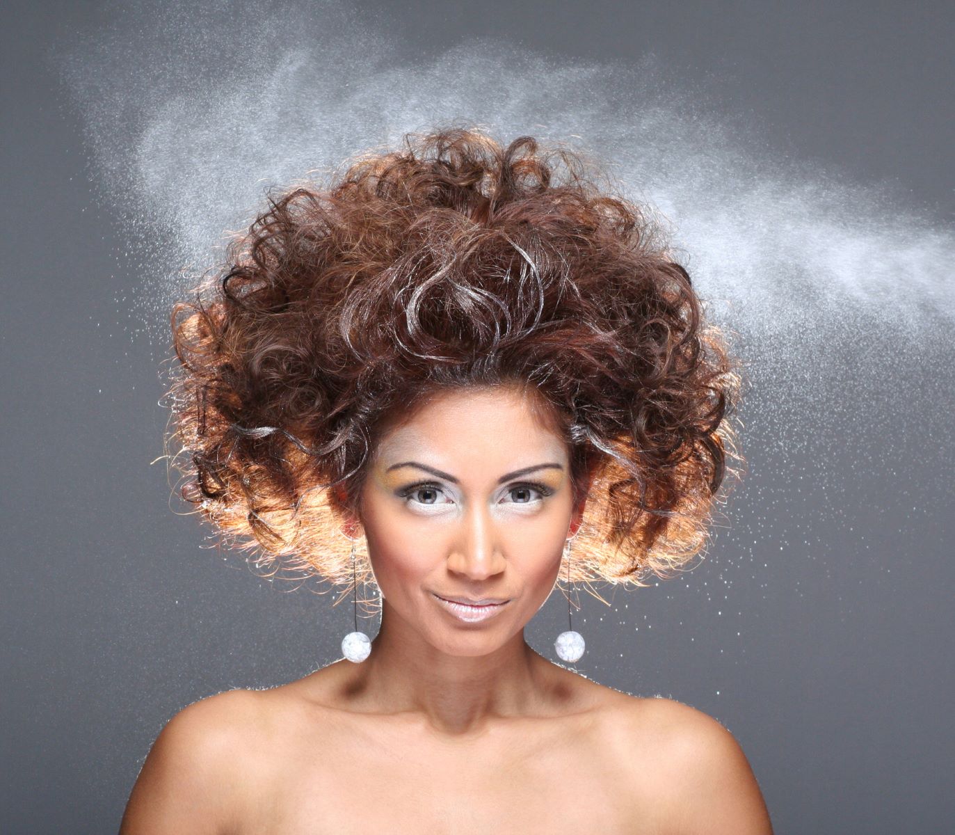 Woman using hairspray for volume and style