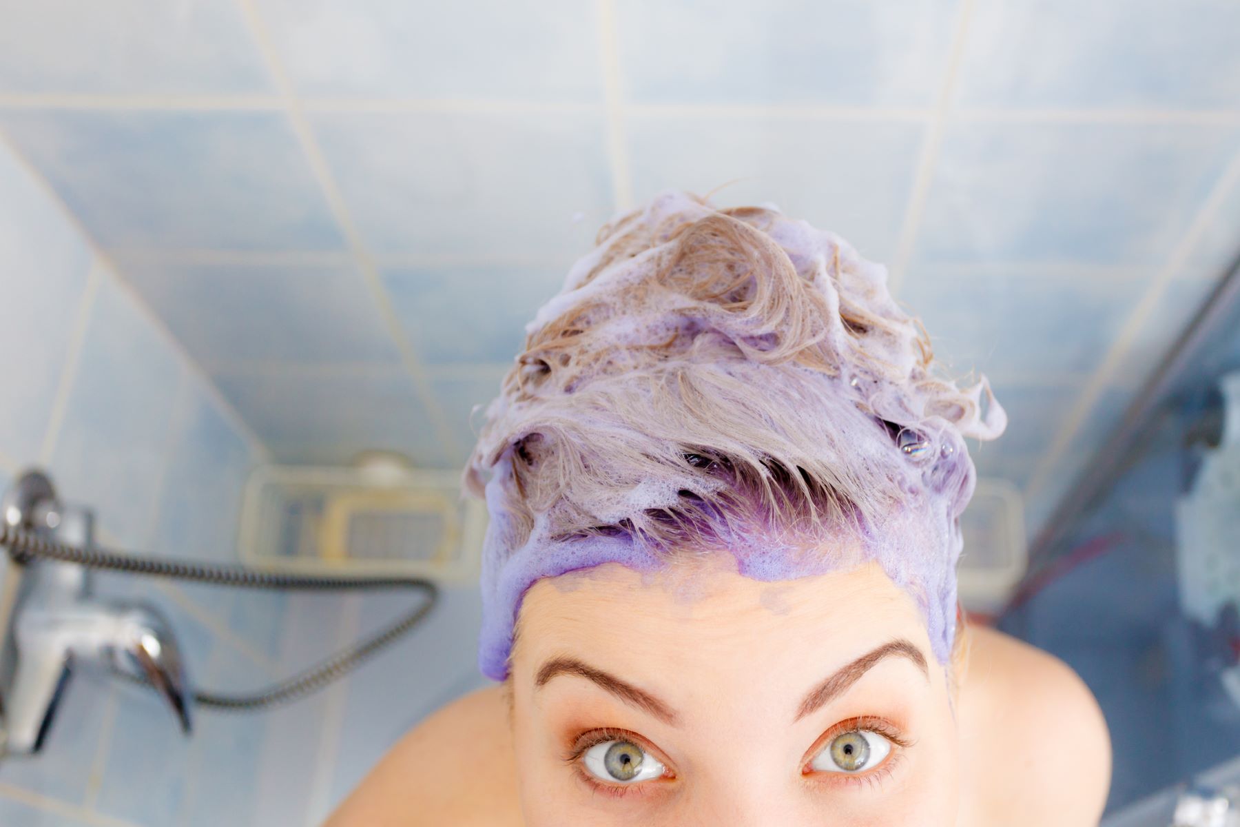 Woman using purple shampoo