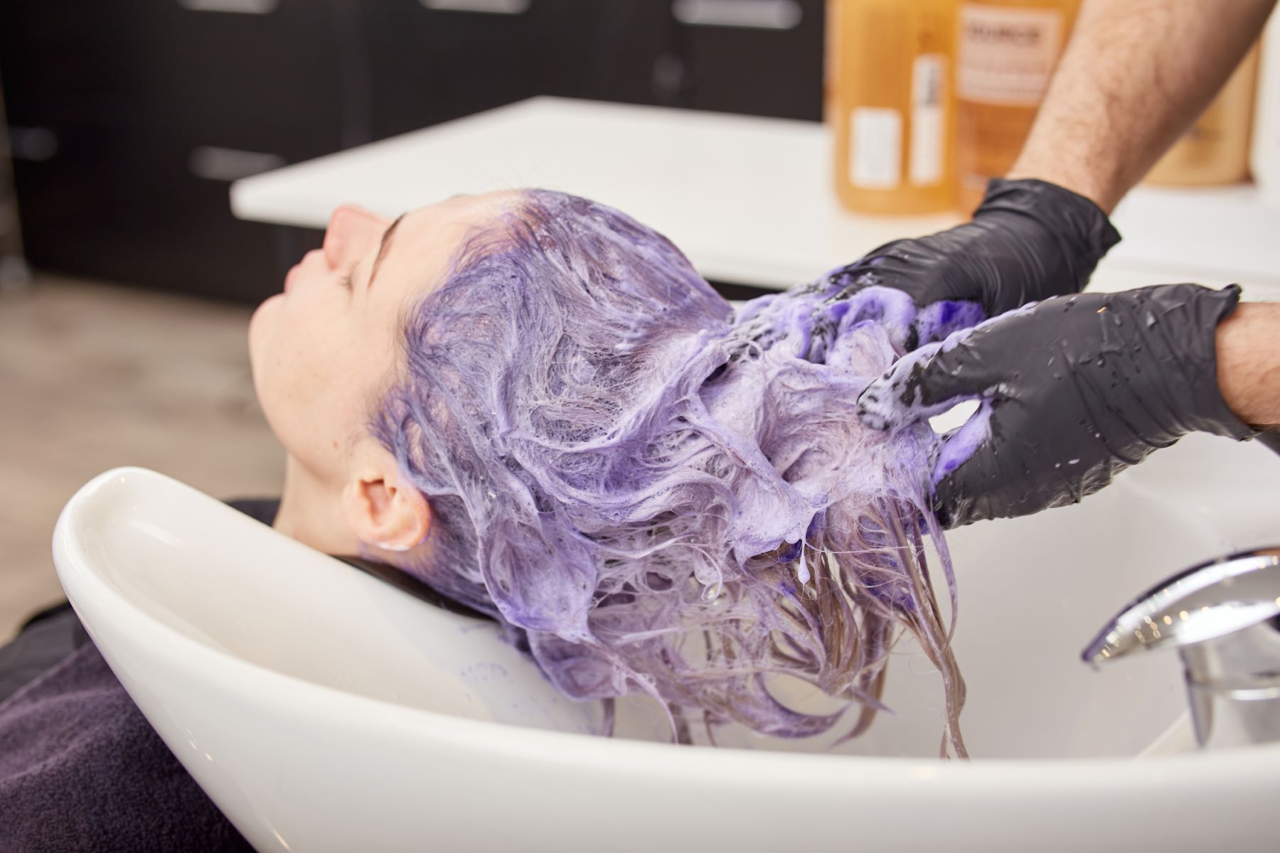Woman using toner after getting highlights