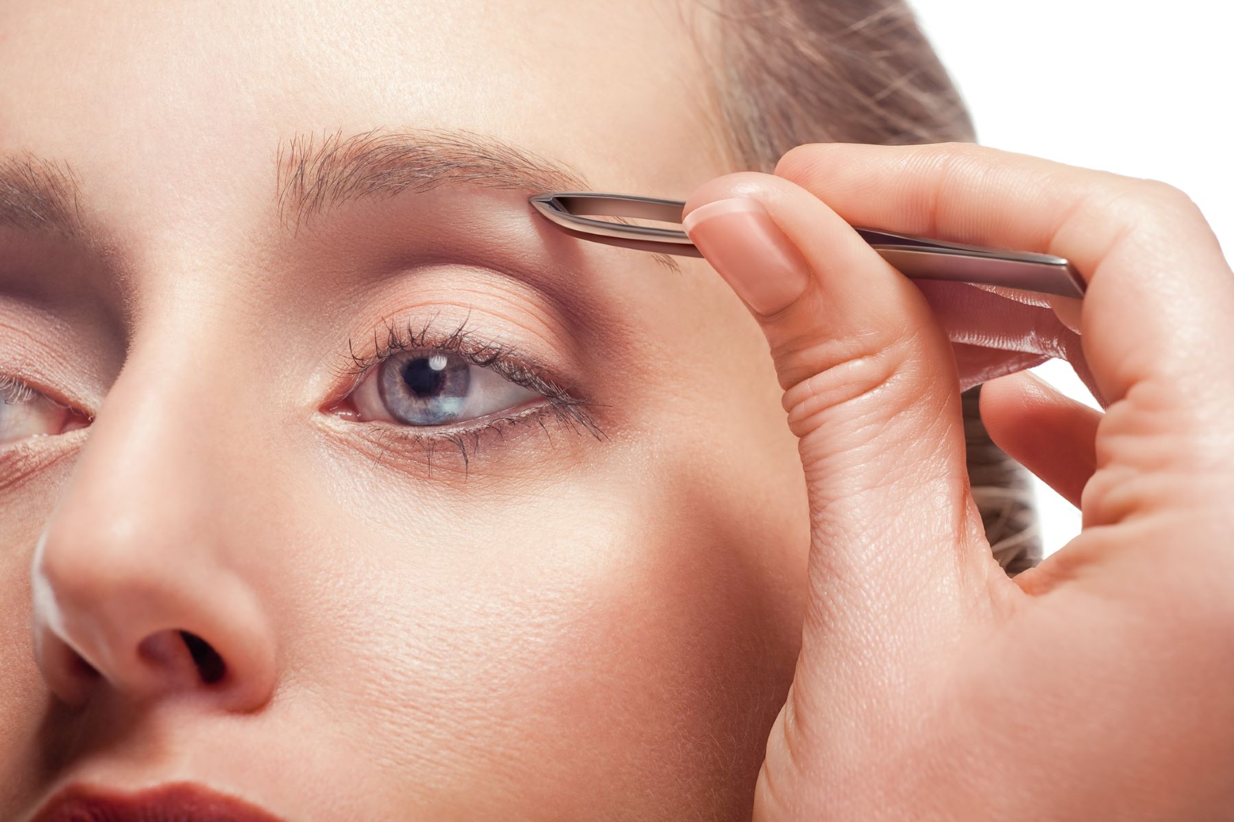 Woman grooming her eyebrows