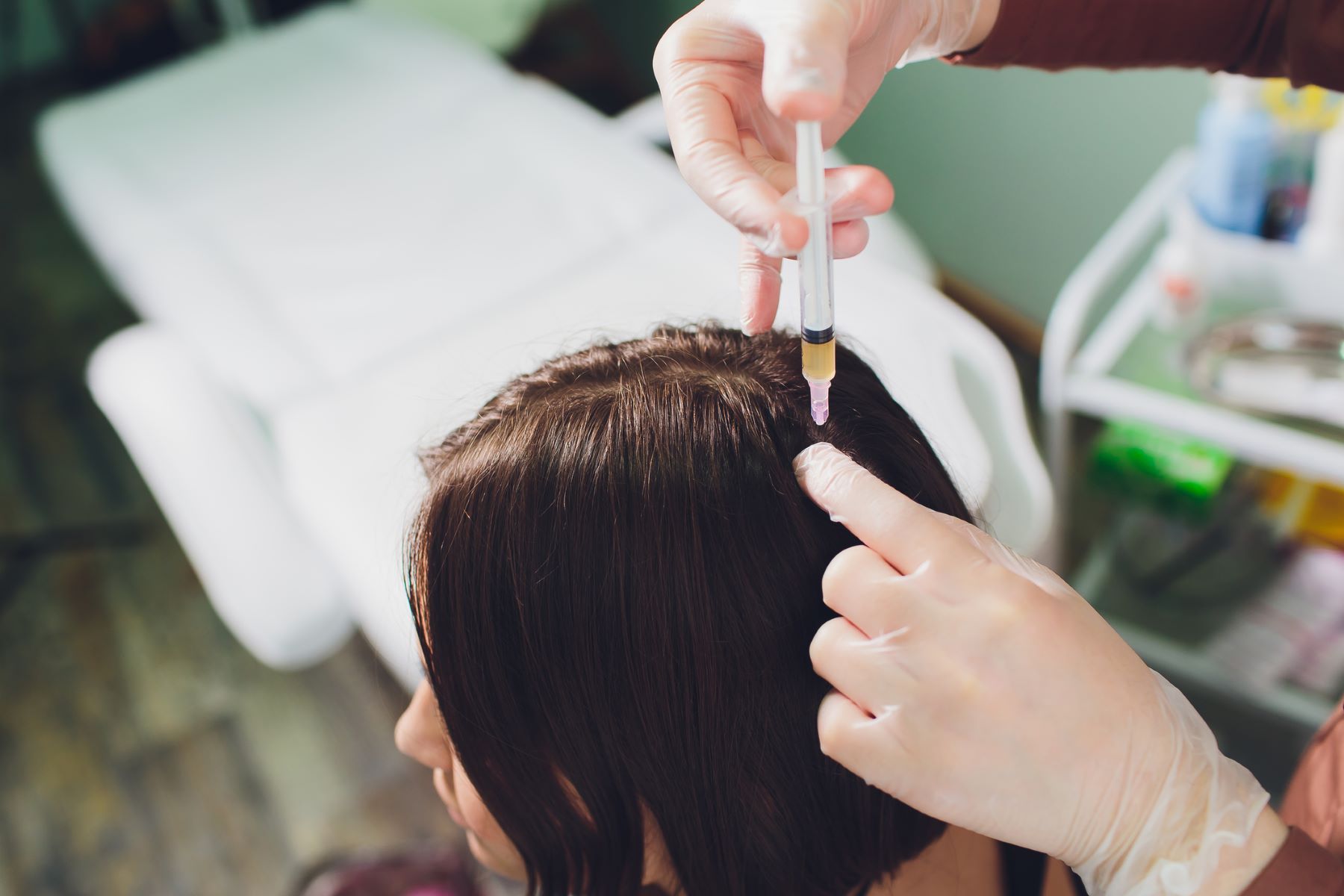 Woman getting hair growth therapy