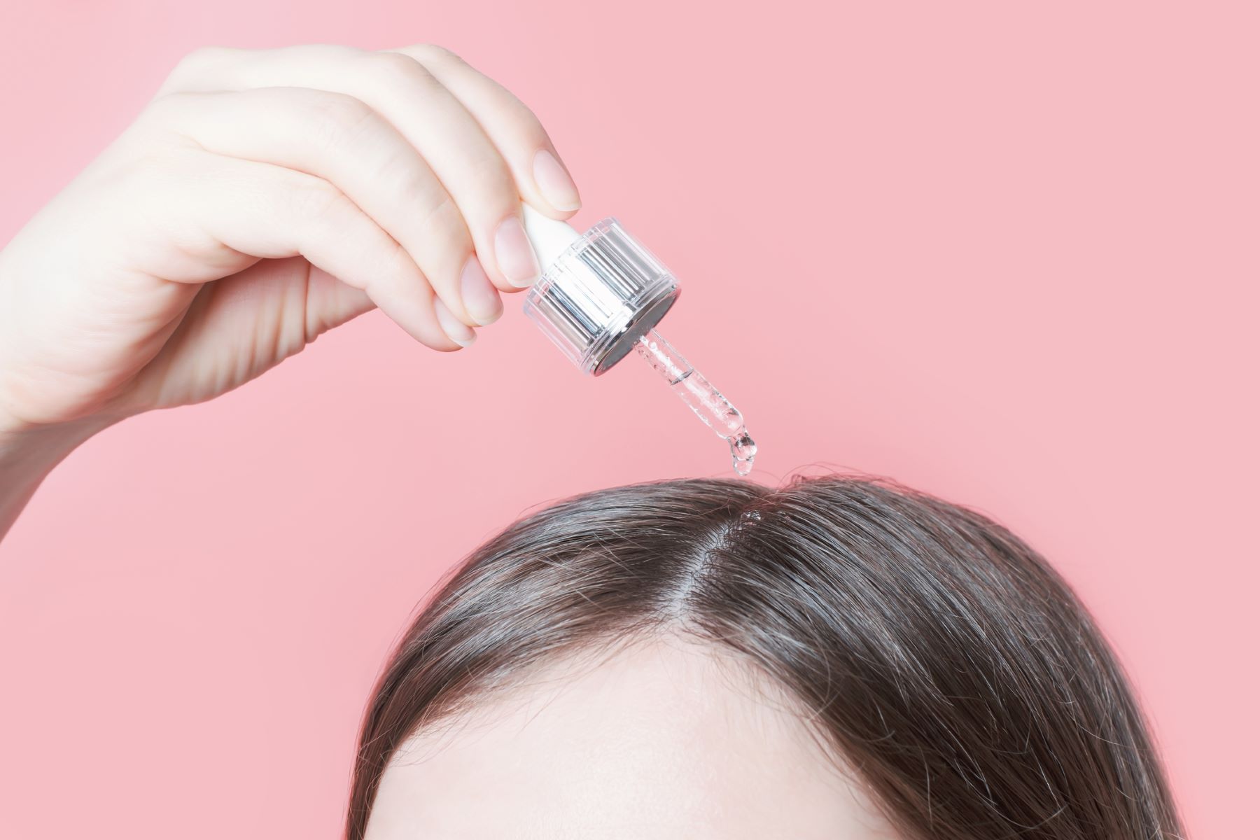 Woman using hair growth medications