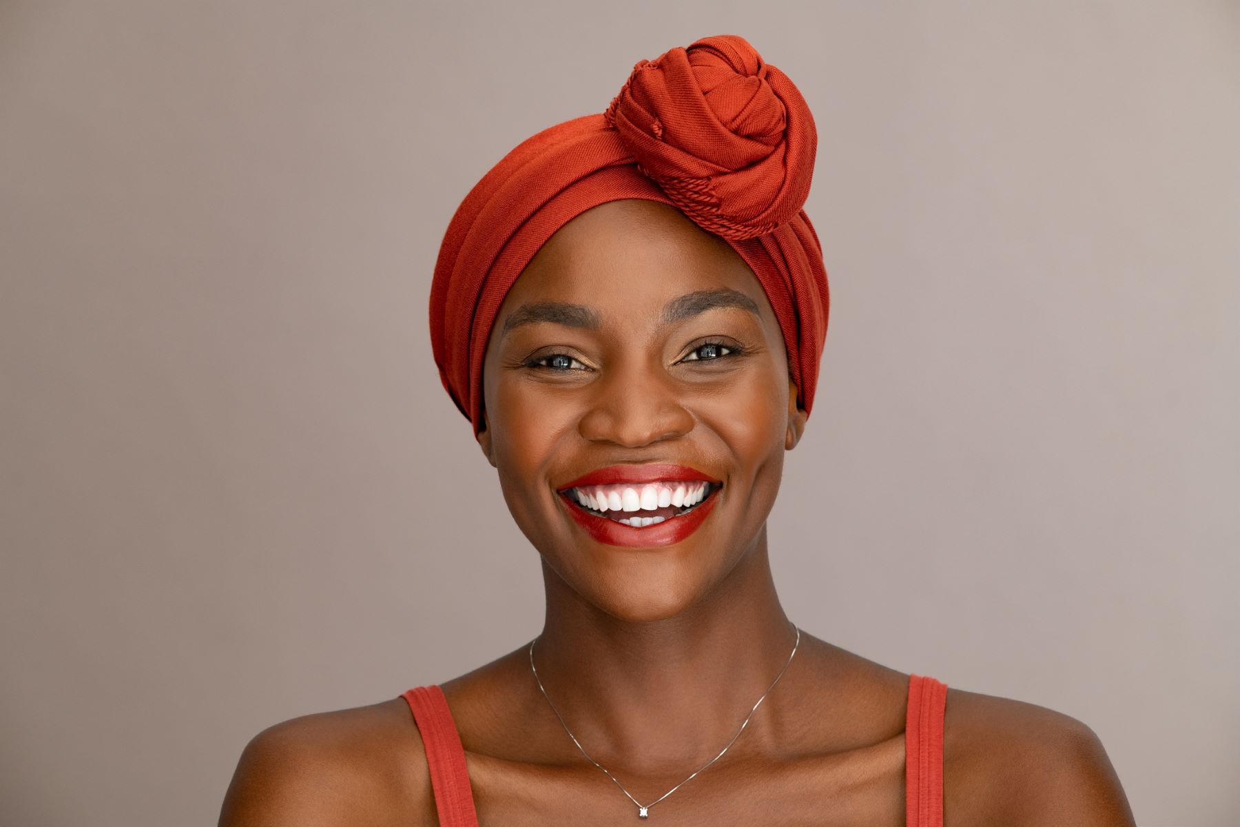 Woman wearing headgear to hide grey roots