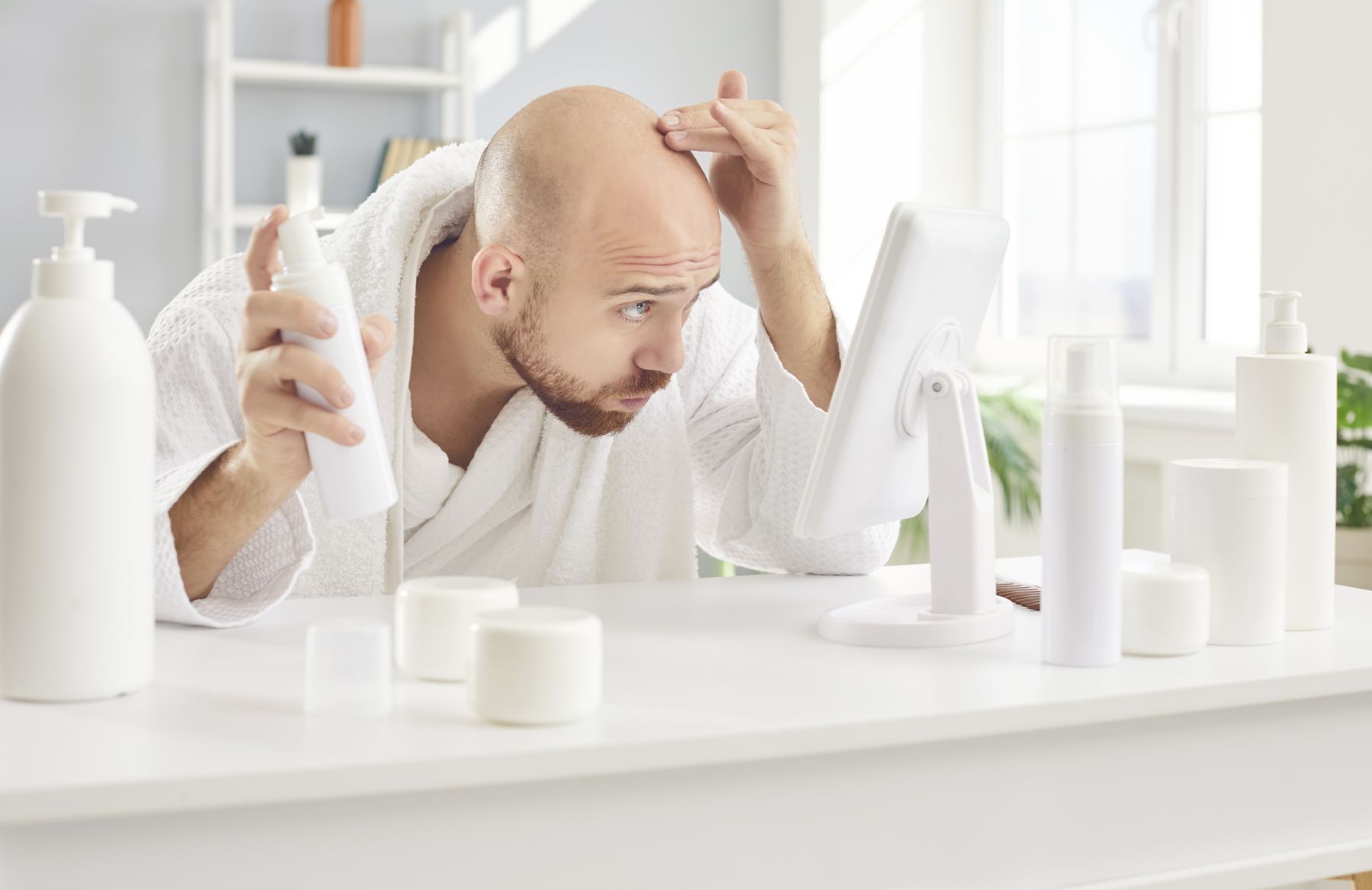 Man trying different hair loss treatments