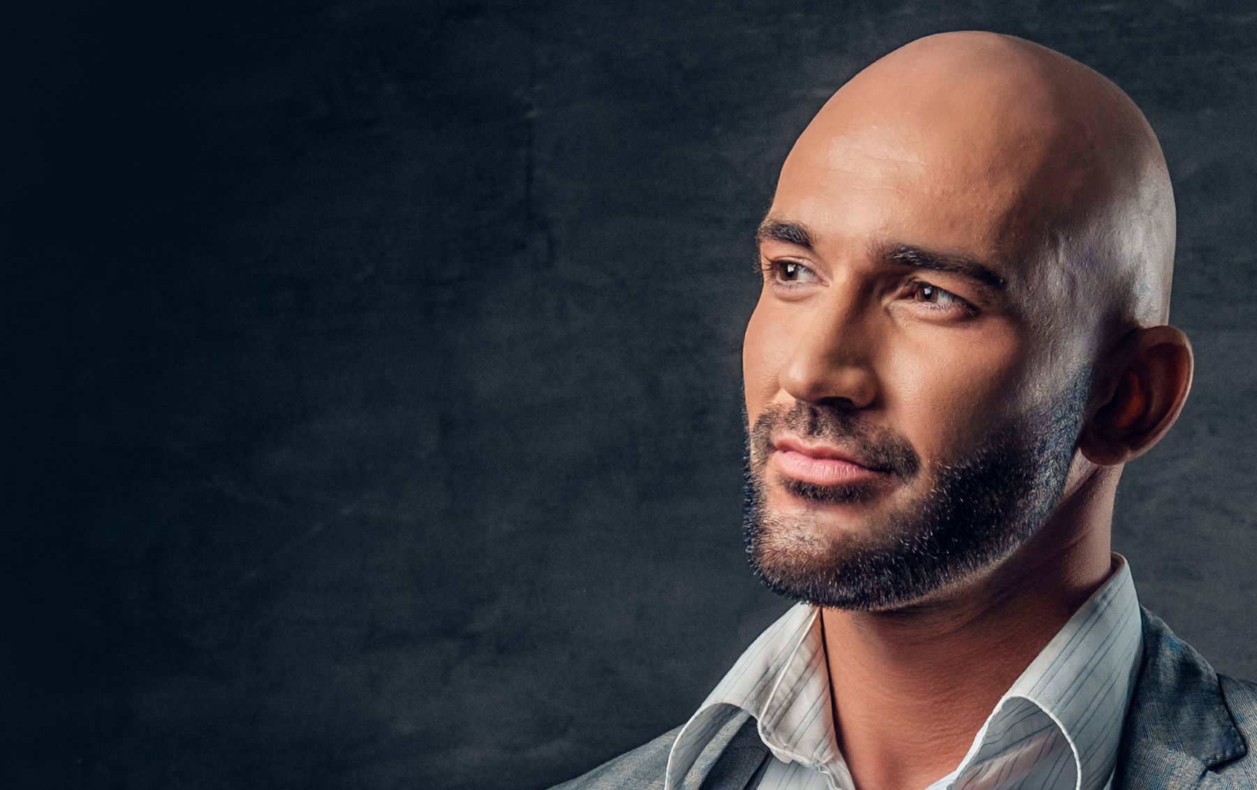 Man with bad receding hairline shaved head