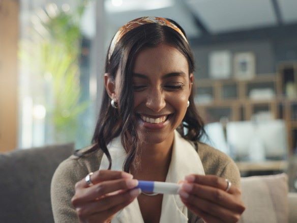 Woman checking a pregnancy test