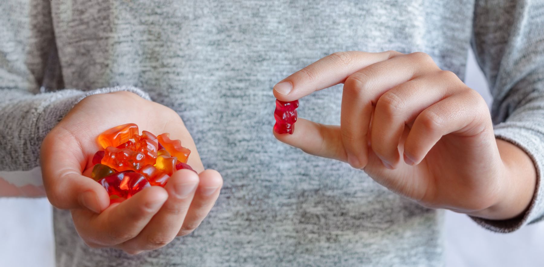 Woman holding hair gummies