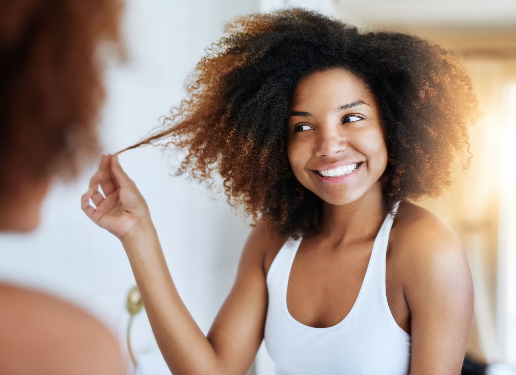 Woman inspects hair after onion juice application