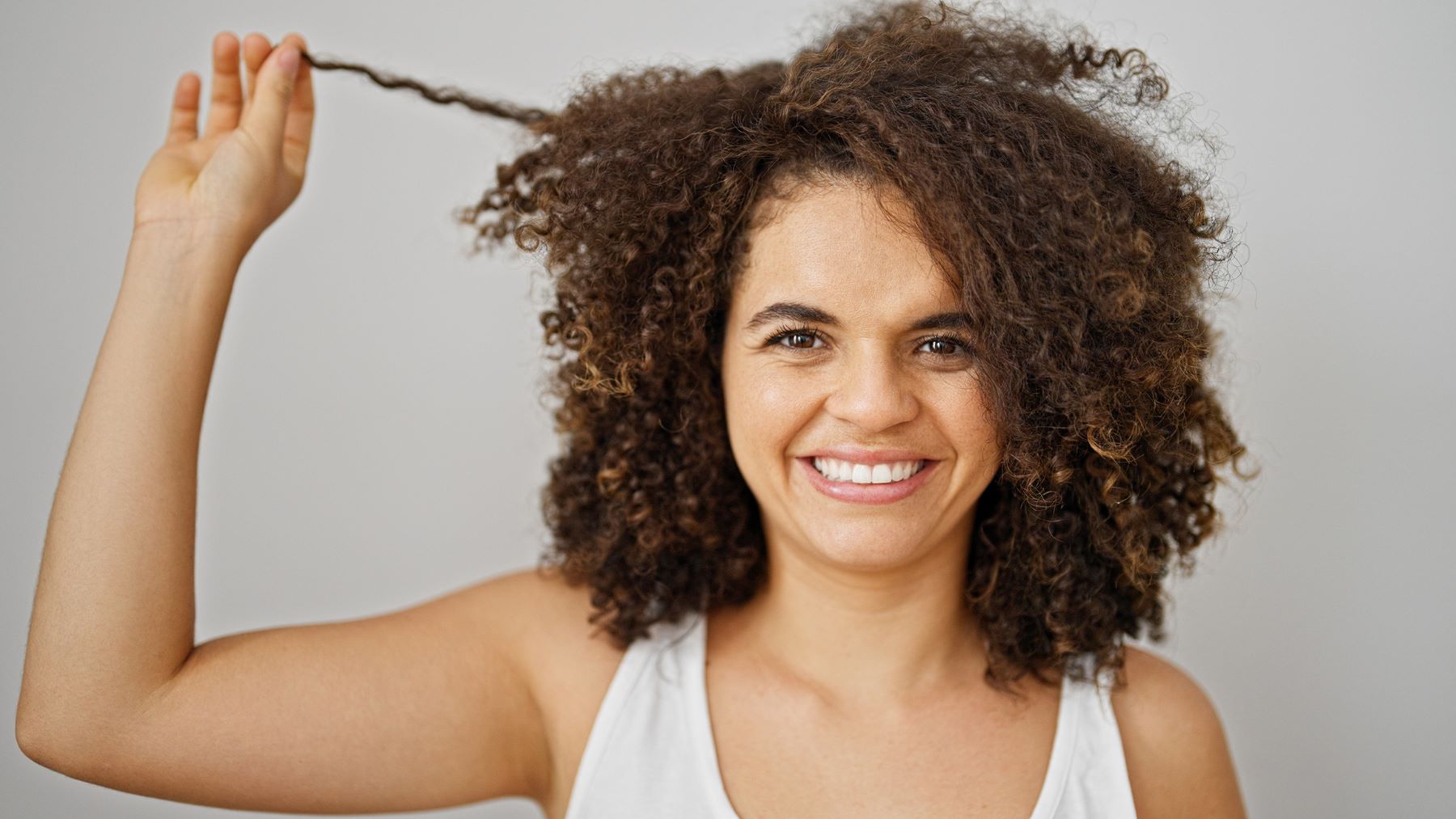 Woman stretching out a hair curl