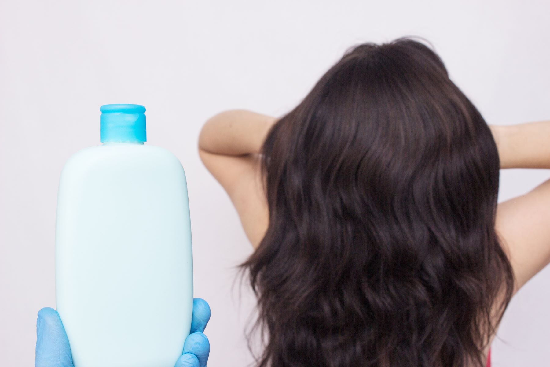 Woman using volumising shampoo