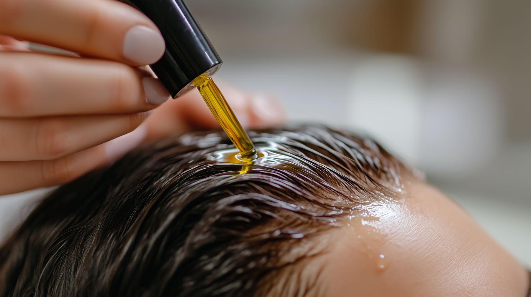 Applying castor oil to the scalp and hair