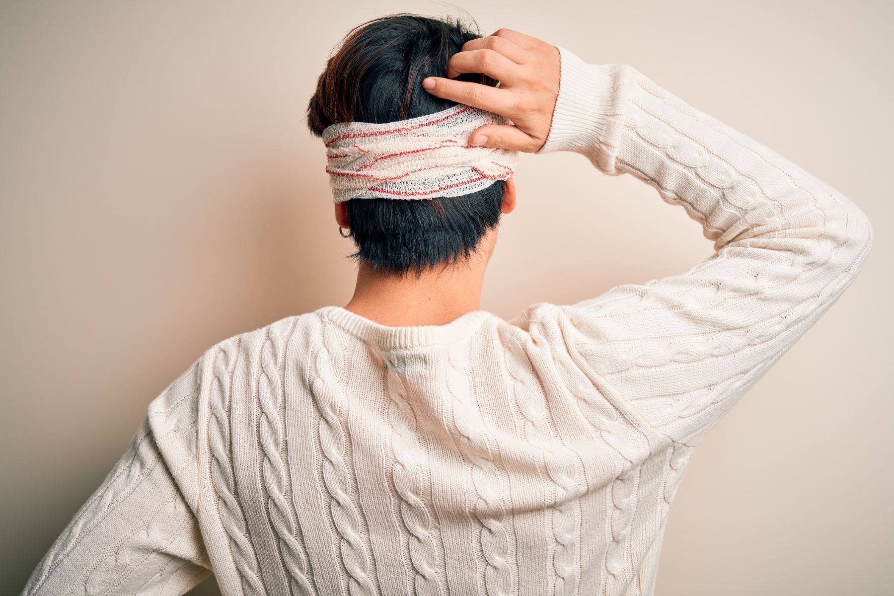 Man about to remove his hair transplant bandage