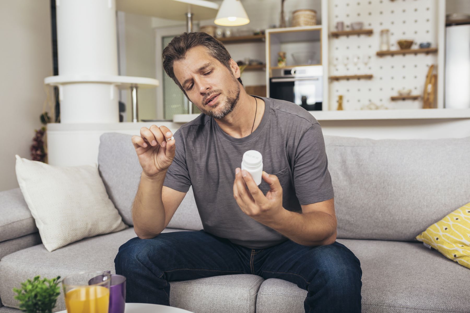 Man reading supplement bottle