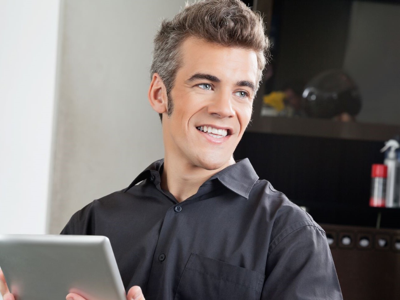 Man using tablet with long sideburns