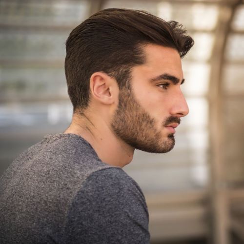 Man with a full beard and dense sideburns