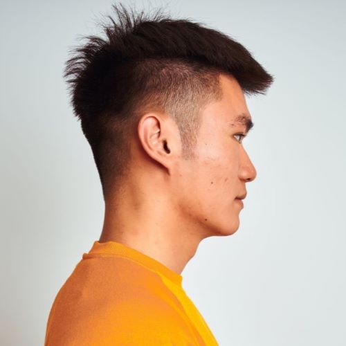 Man with an undercut and shaved sideburns