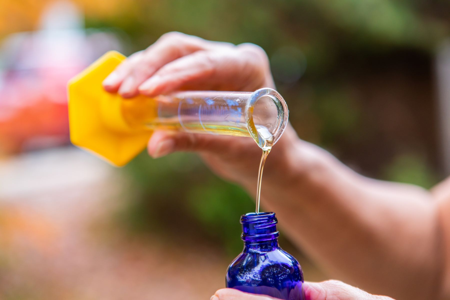 Woman adding batana oil to her shampoo