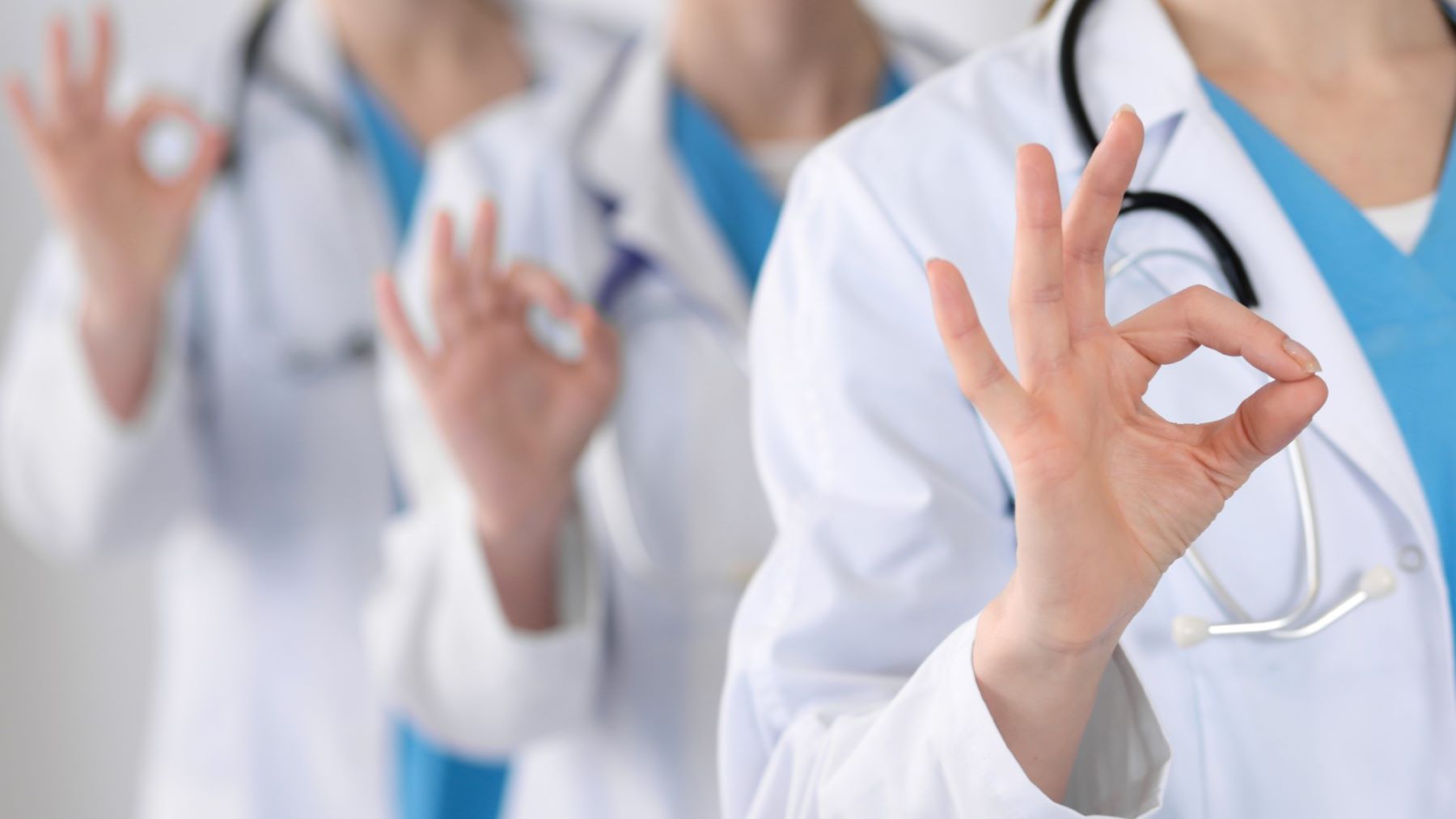 Doctors showing the OK sign