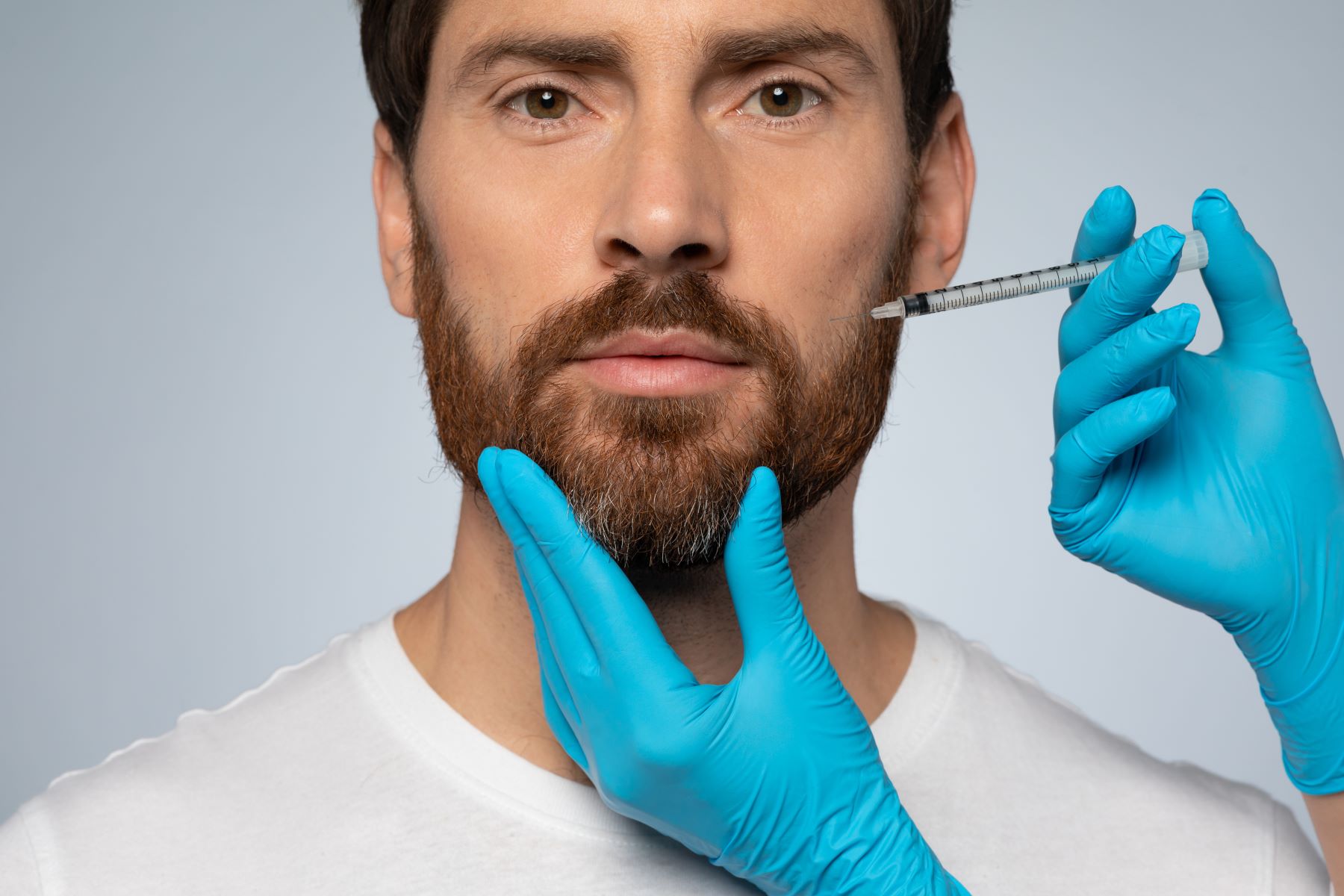 Man receiving platelet rich plasma injection for beard growth