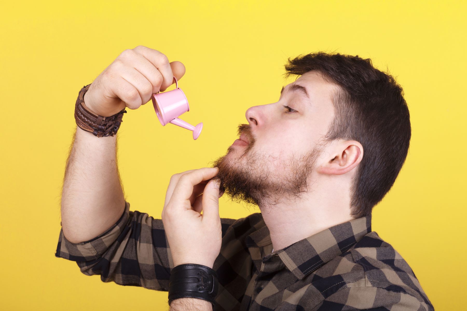 Man watering his beard to promote beard growth