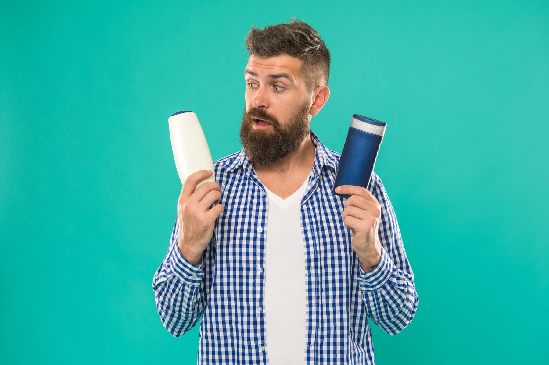 Man choosing between shampoo options