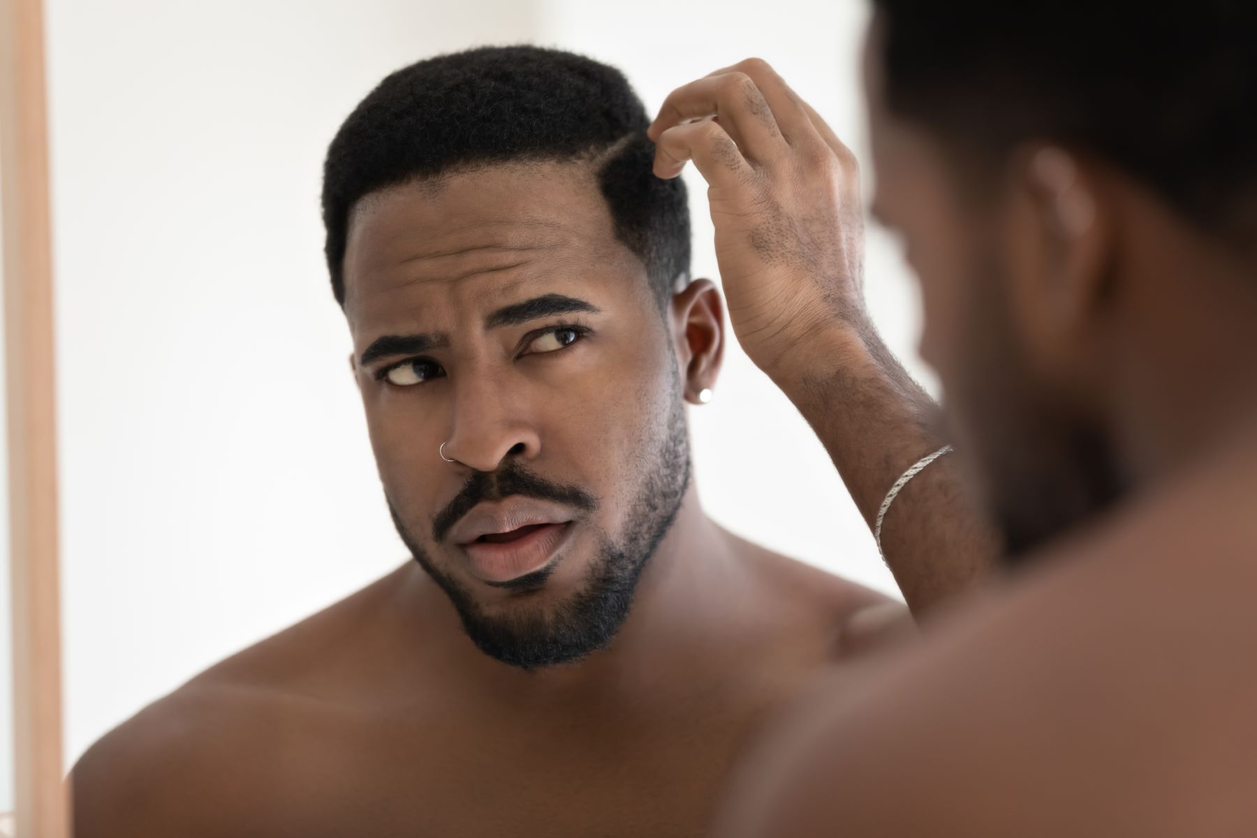 Man examining his hairline